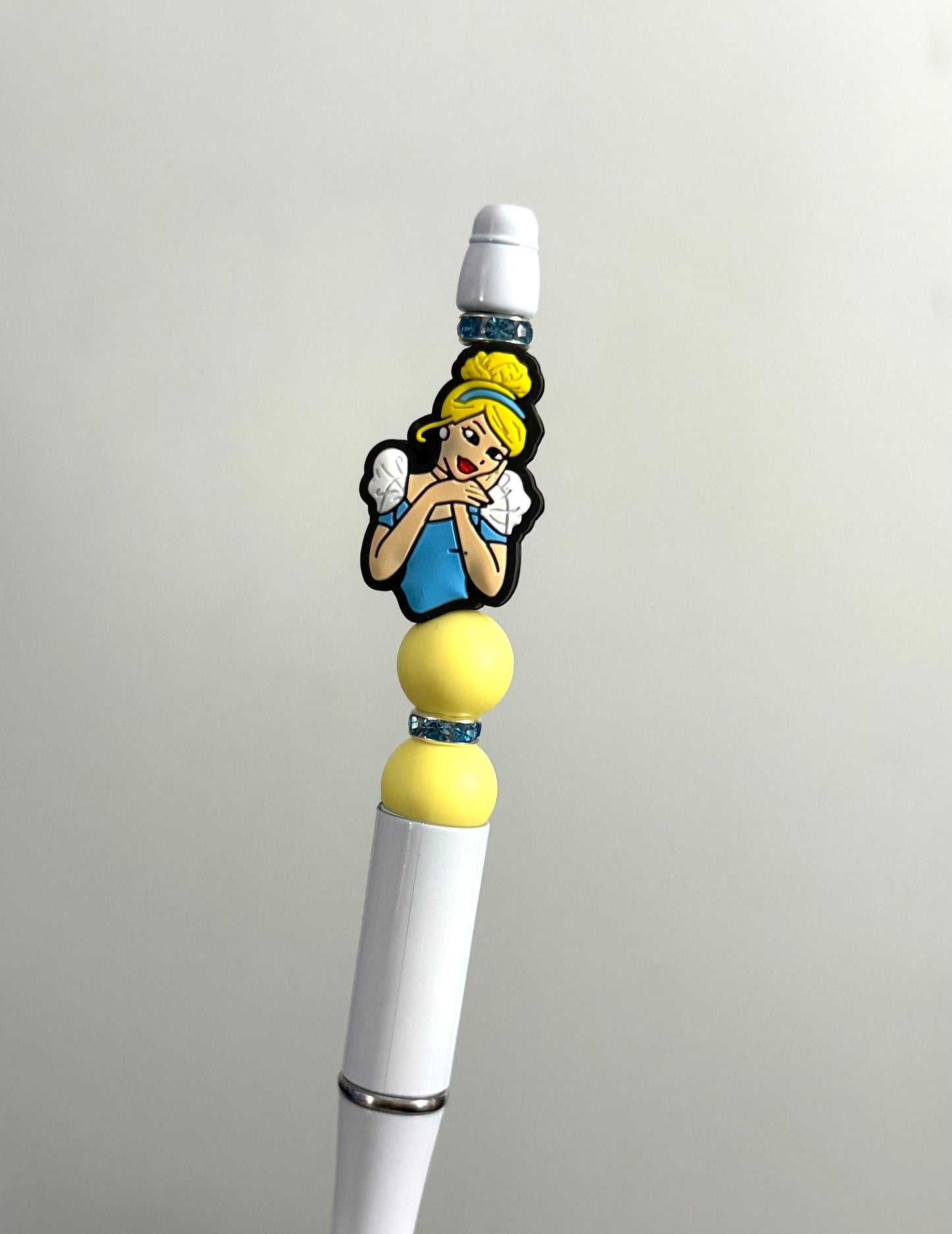 Handmade beaded pen inspired by cinderella, featuring yellow silicone beads and an Alice character charm