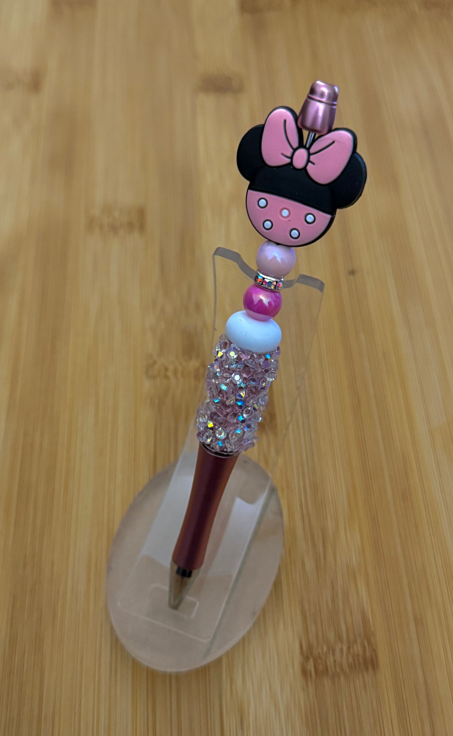 Handmade beaded pen inspired by Minnie Mouse, featuring pink and white beads with a Minnie Mouse character bead