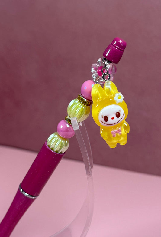 Handmade pink beaded pen inspired by the Labubu Character, featuring pink and light yellow beads and a yellow
Labubu character charm