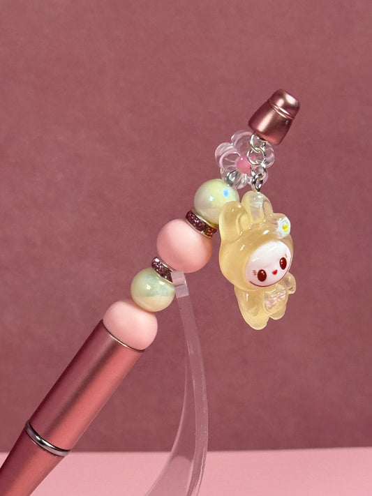 Closer view of a Handmade metallic pink beaded pen inspired by the Labubu Character, featuring pink and light green beads and a yellow
Labubu character charm