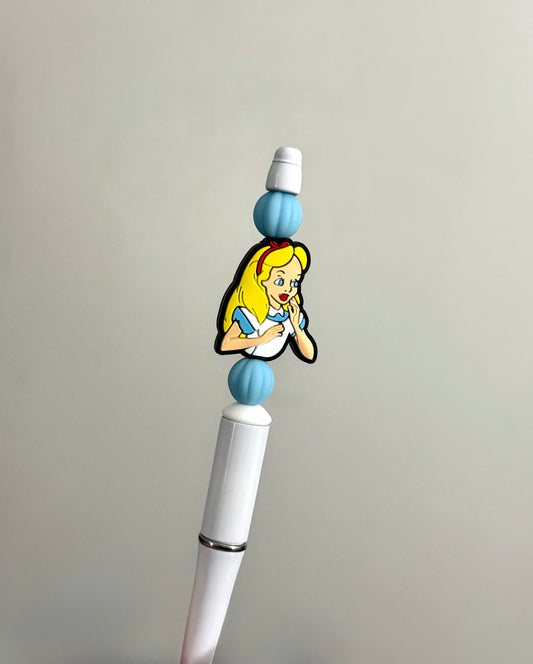 Handmade beaded pen inspired by Alice in Wonderland, featuring blue and white beads and an Alice character charm