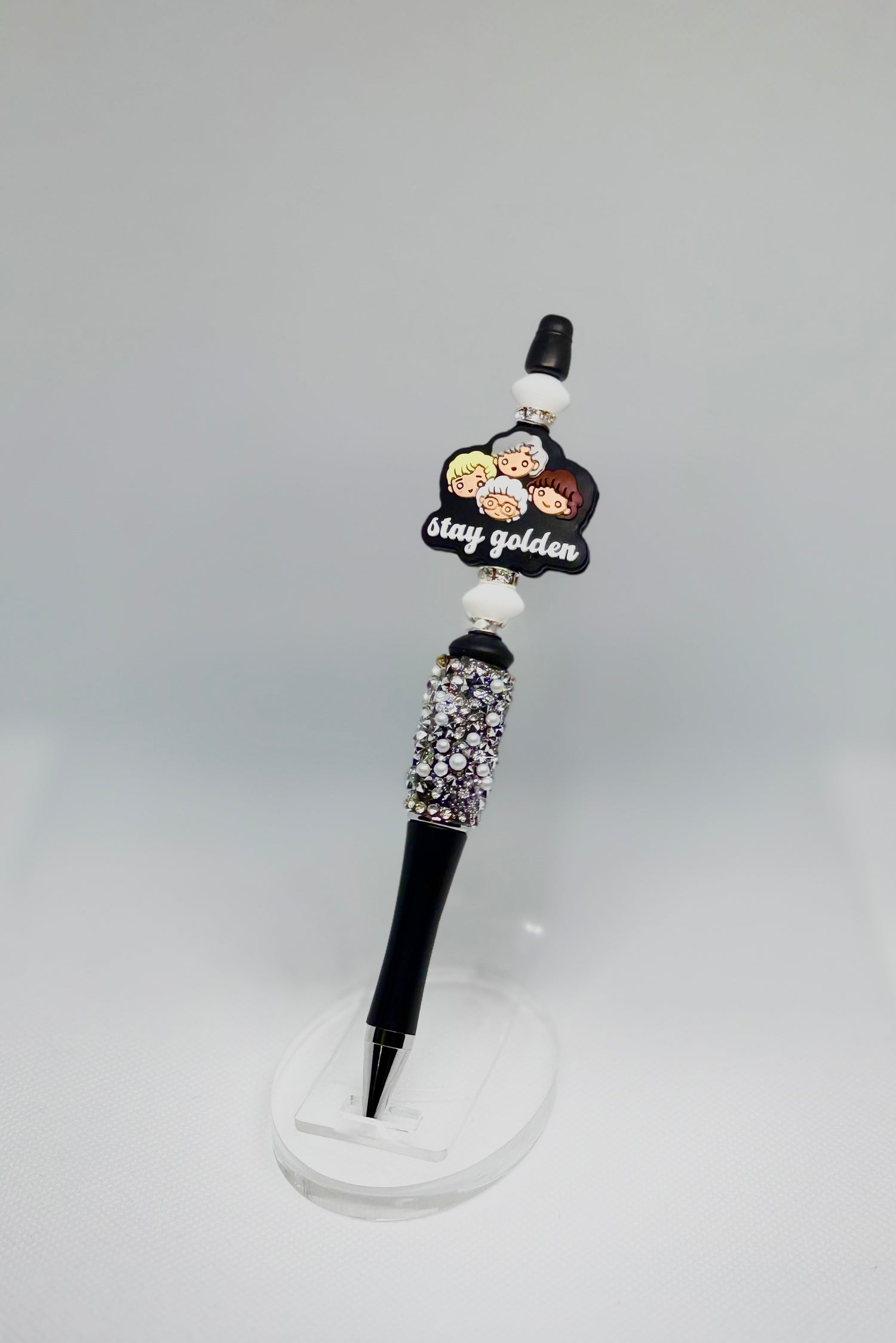 Handmade black bedazzled beaded pen inspired by golden girls, featuring white and black beads and a stay golden character bead