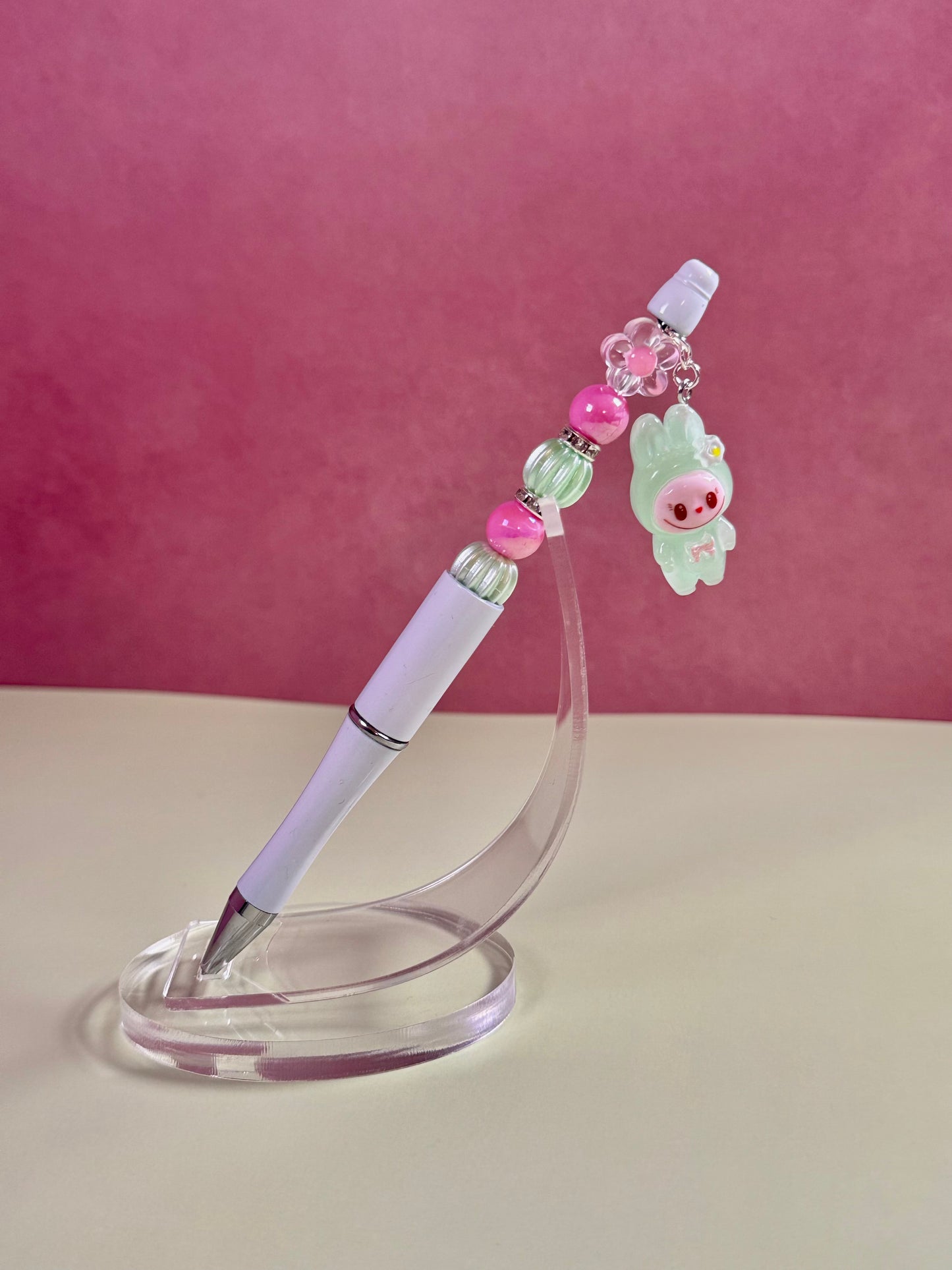 Handmade white beaded pen inspired by the Labubu Character, featuring pink and light green beads and a green
Labubu character charm