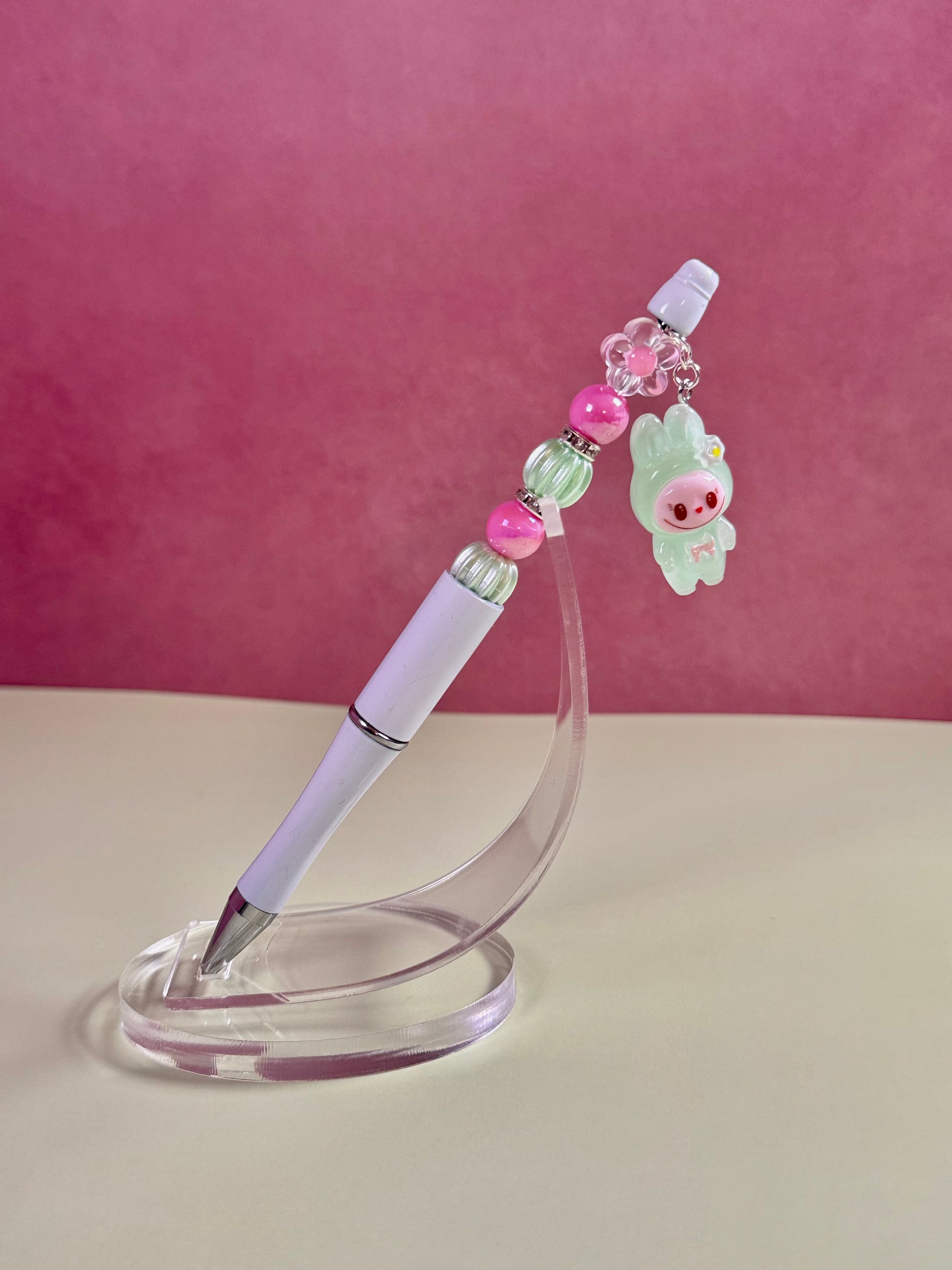 Handmade white beaded pen inspired by the Labubu Character, featuring pink and light green beads and a green
Labubu character charm